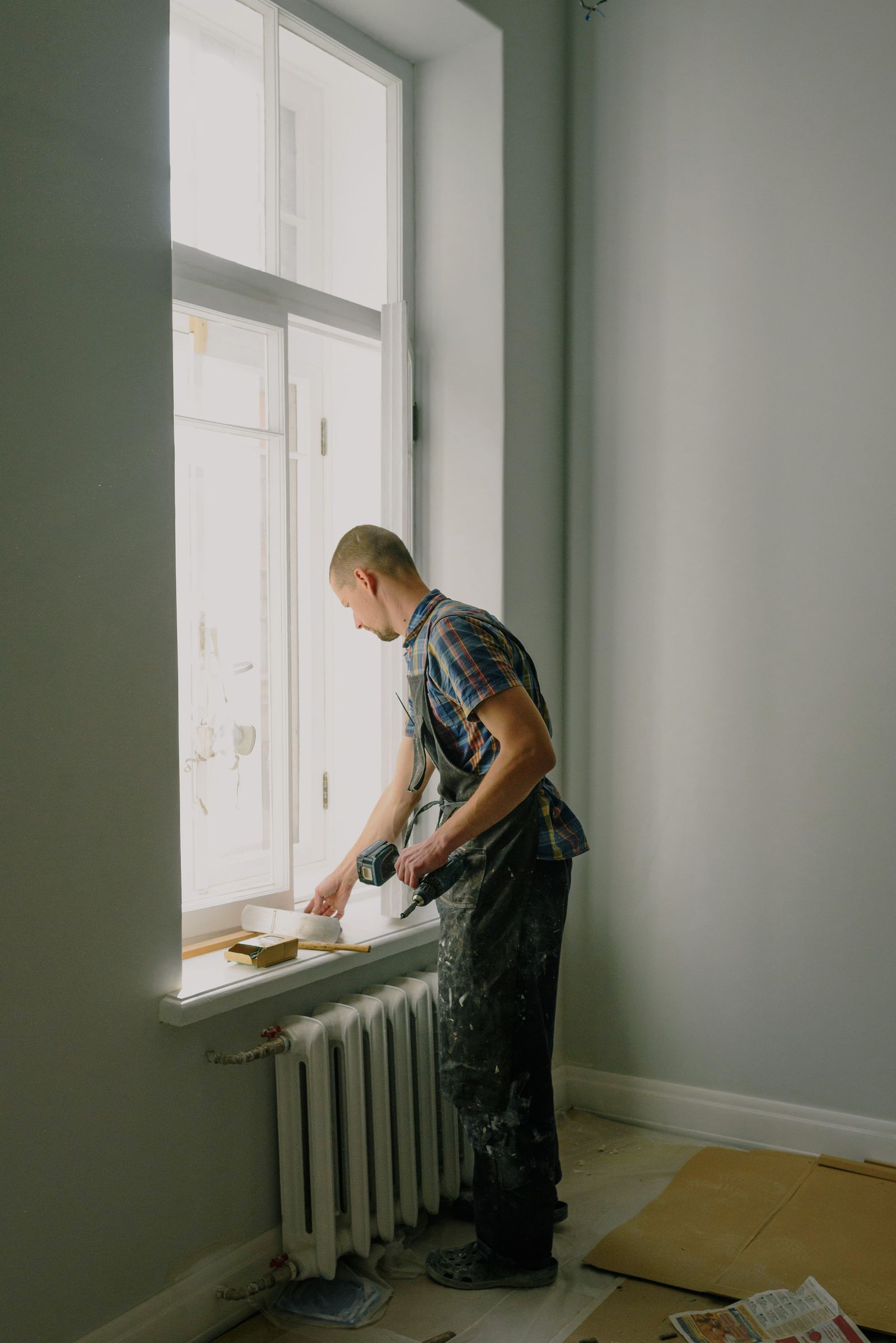 Tradesperson starting work in a cleanly stripped room